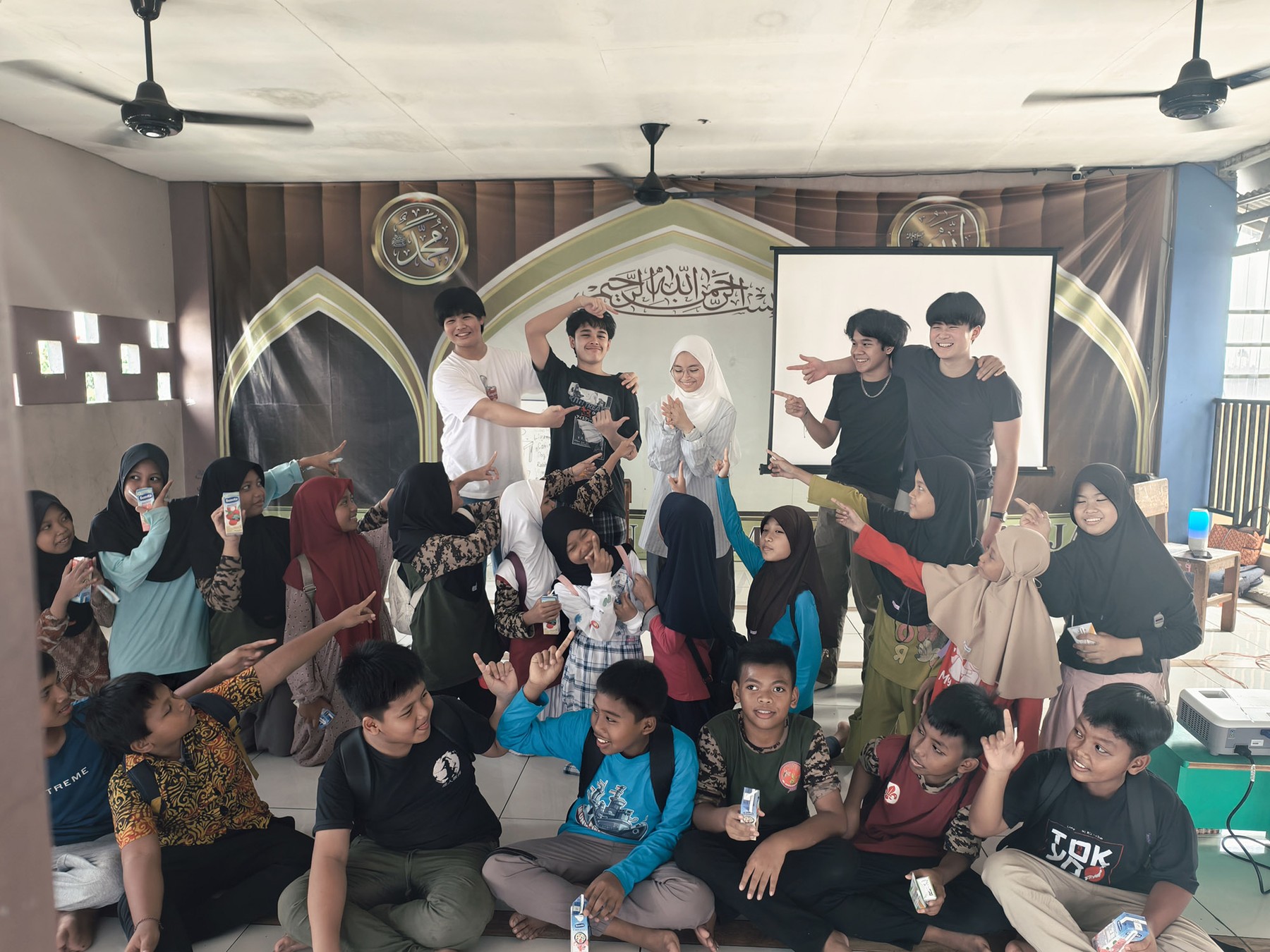 Abhipraya volunteers and students posing together in the learning space