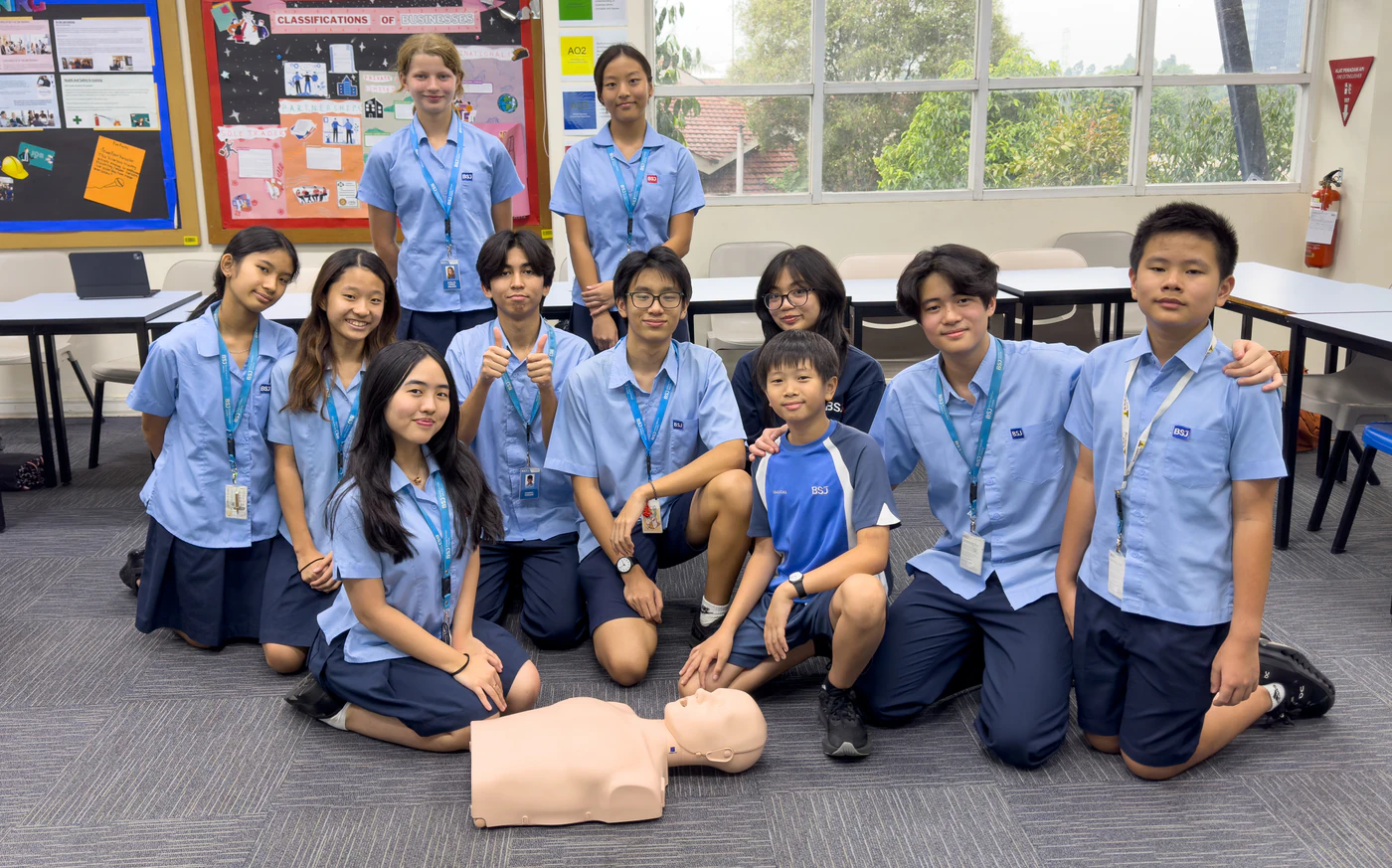 Students at British School Jakarta gathered around a CPR training manikin during a Beatkeepers workshop